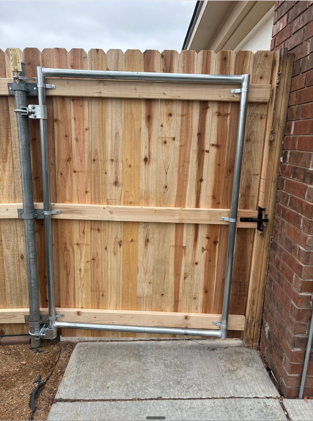 Wood fence gate frame on galvanized steel posts