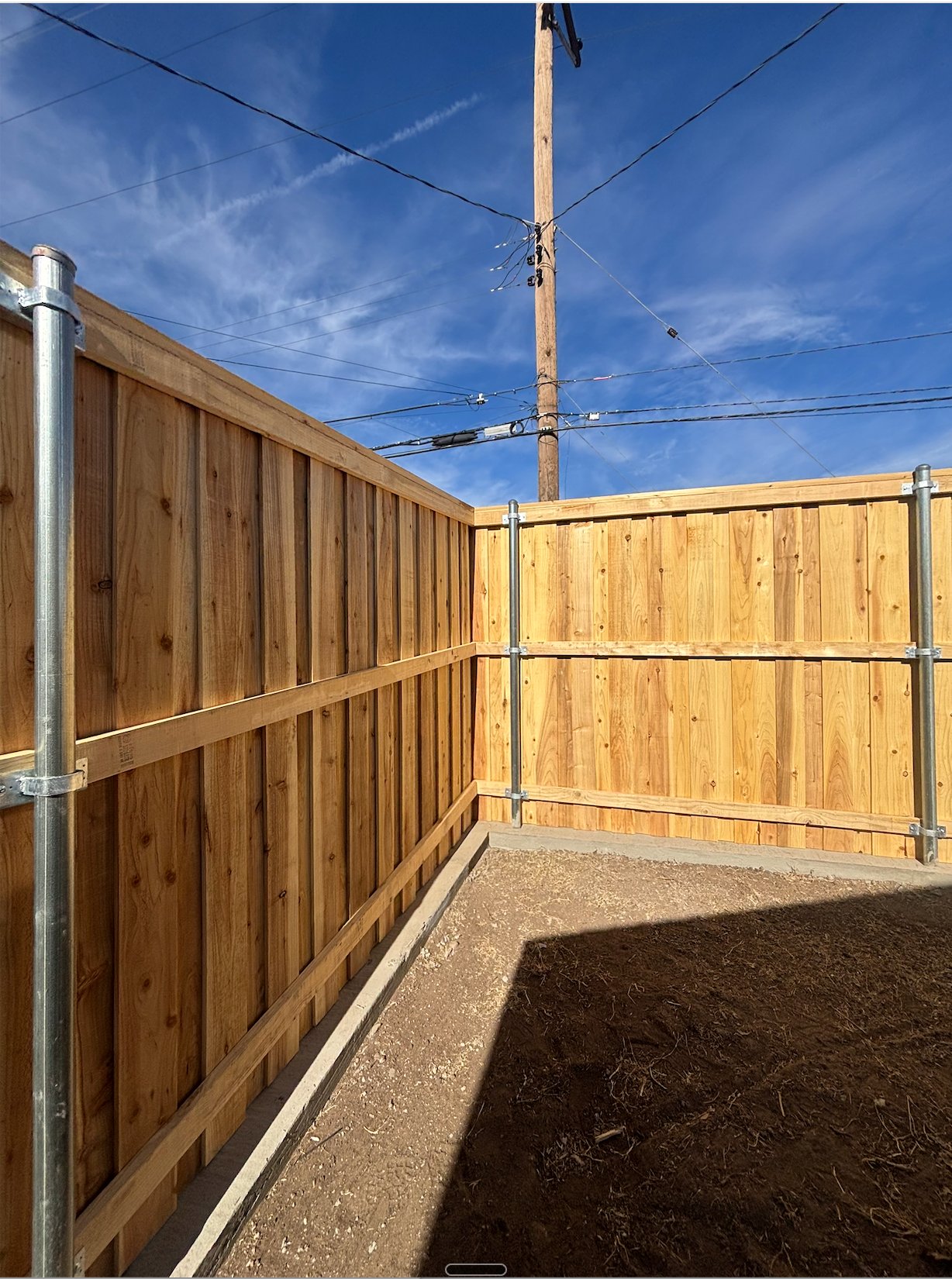 New cedar privacy fence corner installation