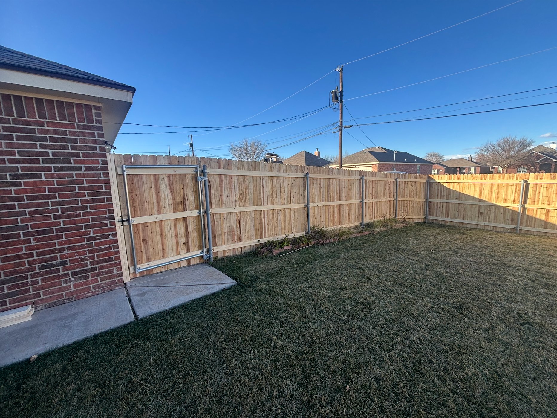 Wood privacy fence with backyard gate, residential install