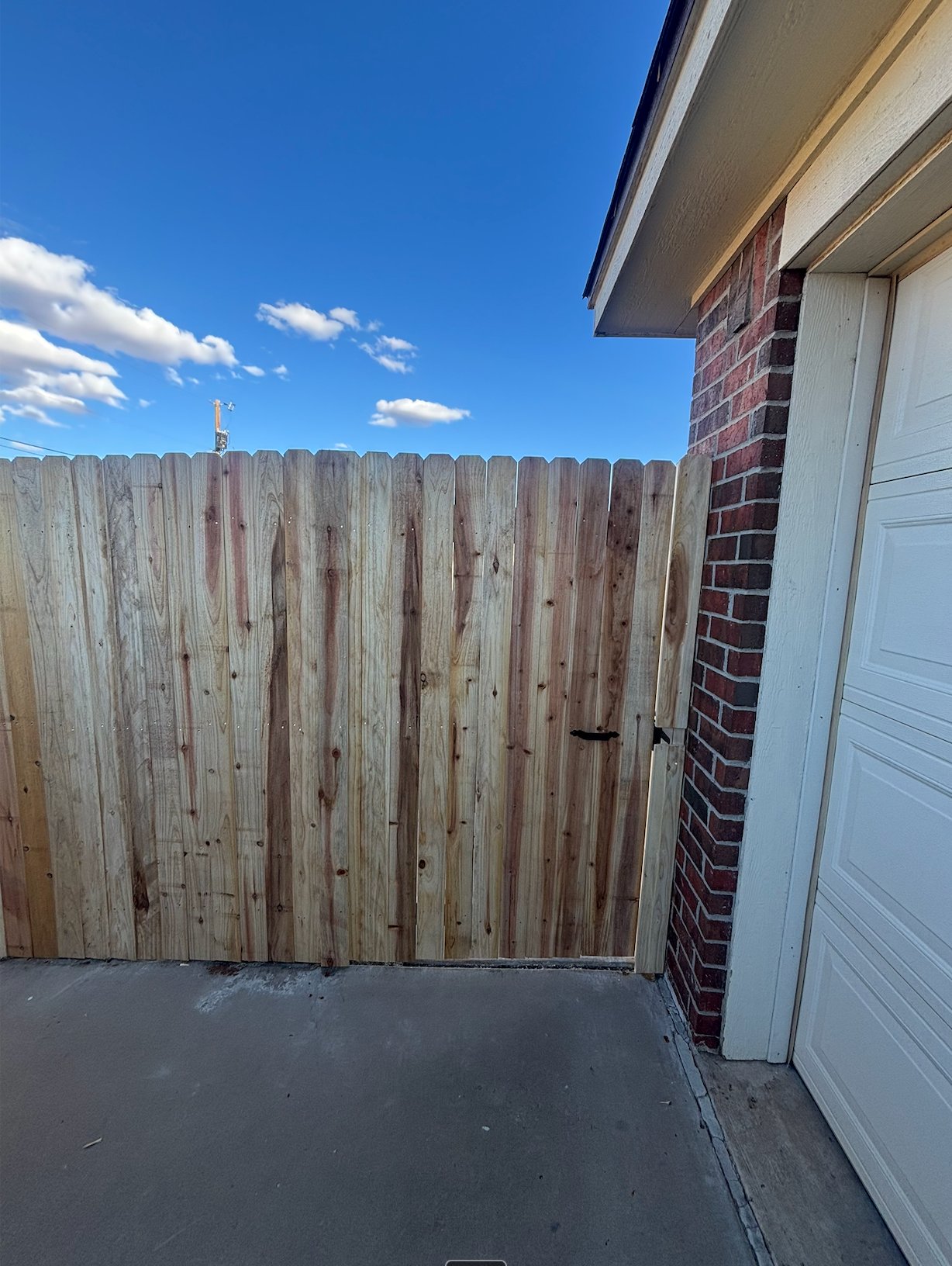 Wood fence gate at garage side yard entrance
