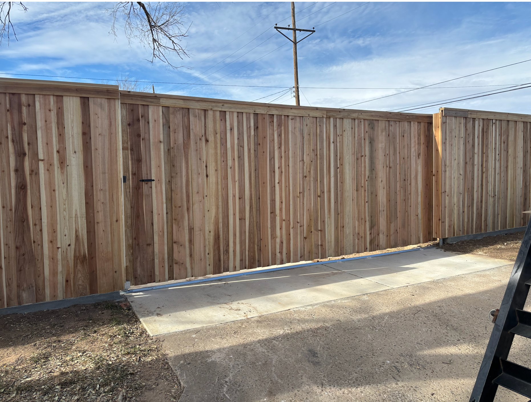 Board-on-board cedar privacy fence with gate