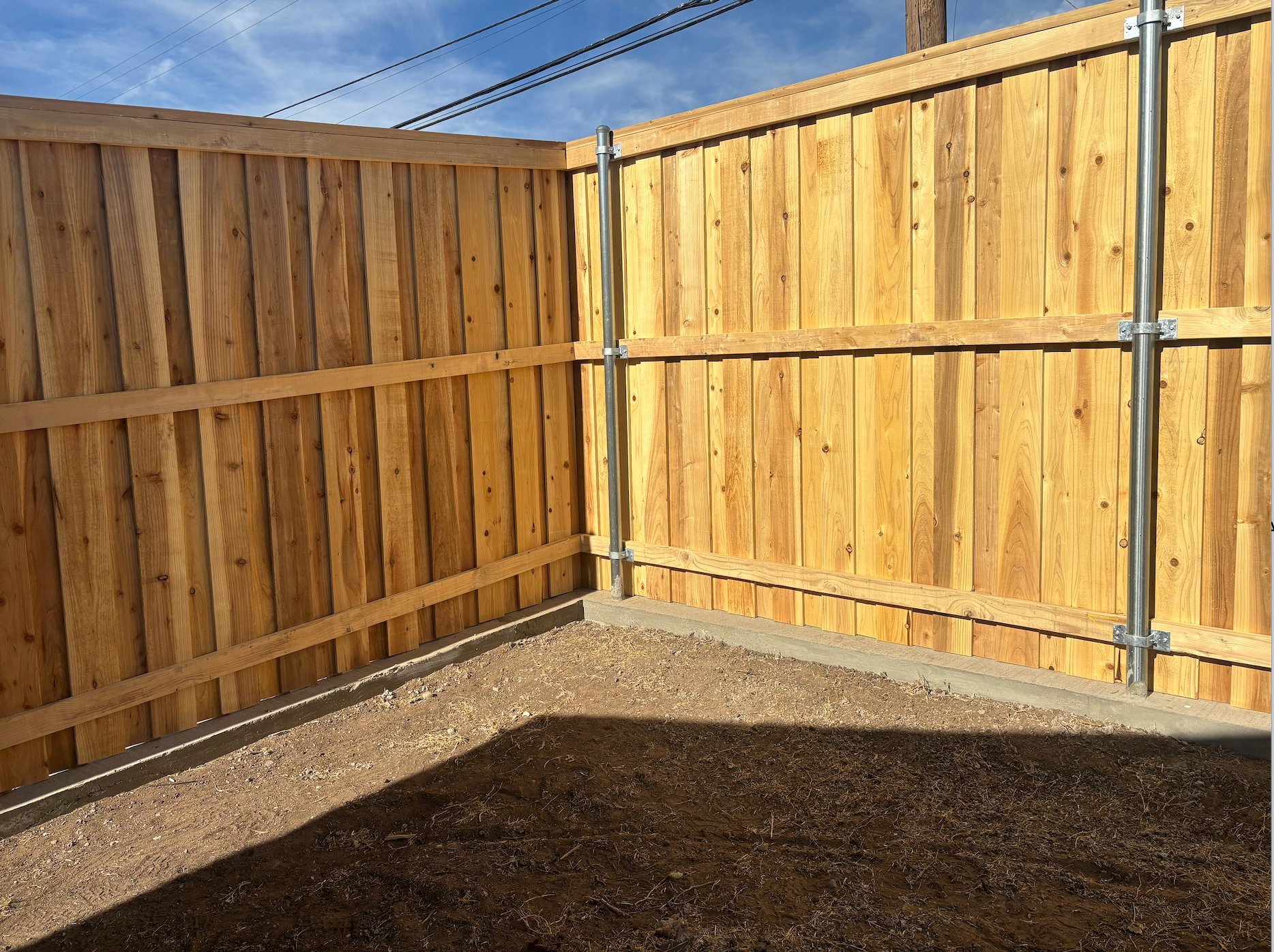 Cedar board-on-board fence corner under construction
