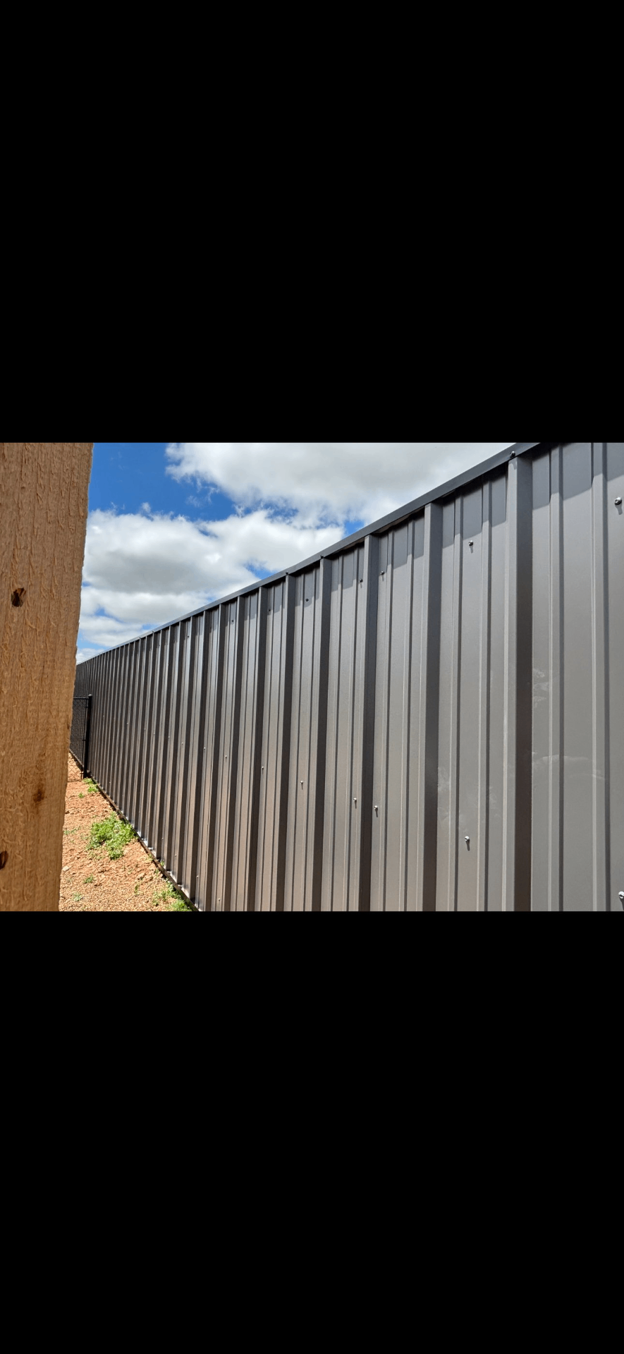 Gray sheet metal fence, commercial grade build
