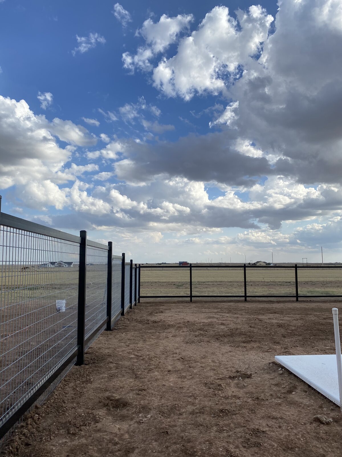 Welded wire fence with black metal frame on Panhandle property