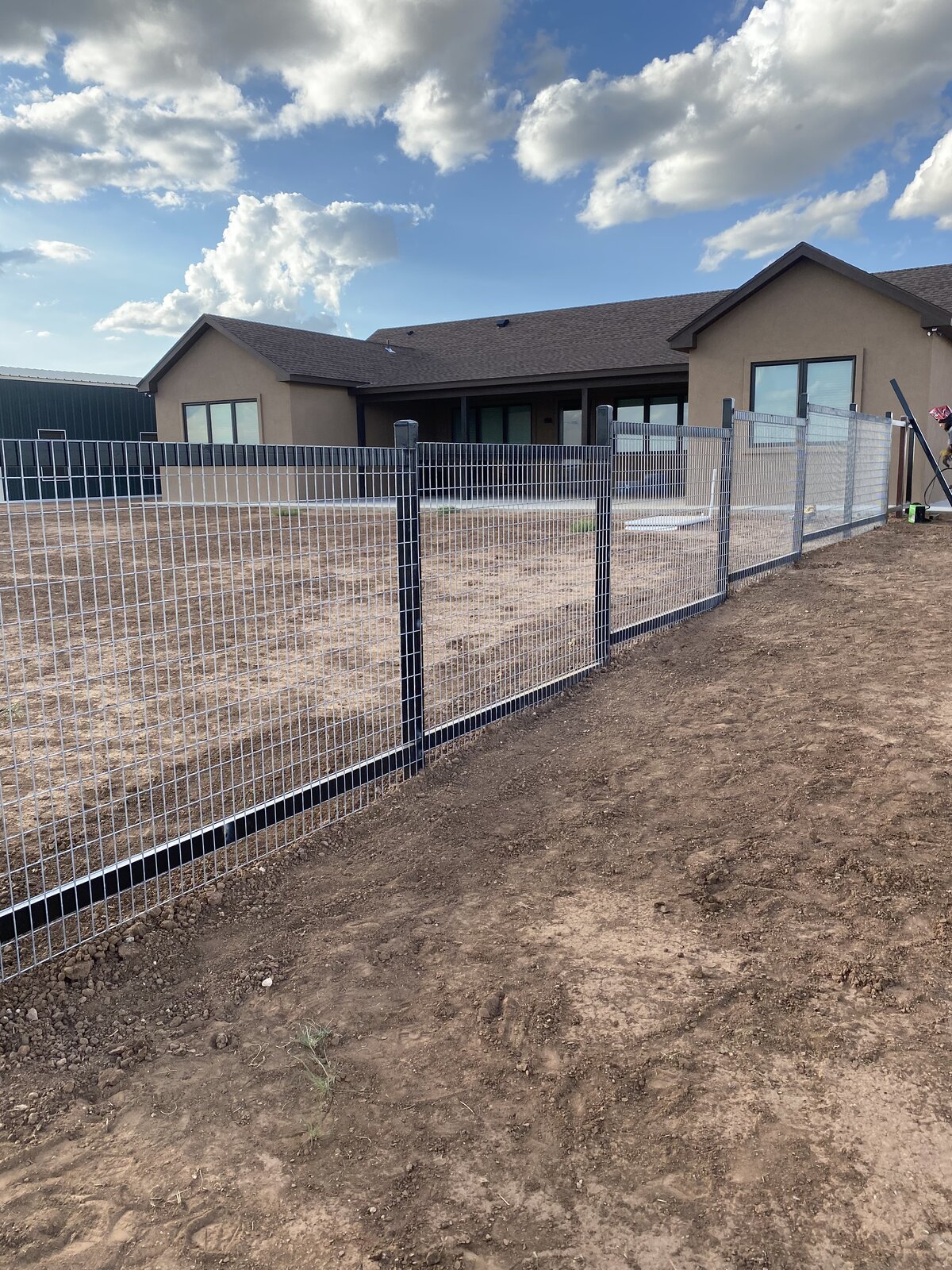 Residential wire mesh fence around an Amarillo home