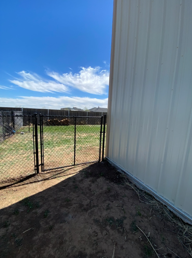 Black chain link fence with gate on a side yard in Amarillo, TX