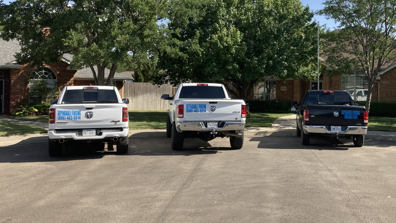 Dependable Fencing crew trucks lined up at a residential fence job in the Texas Panhandle